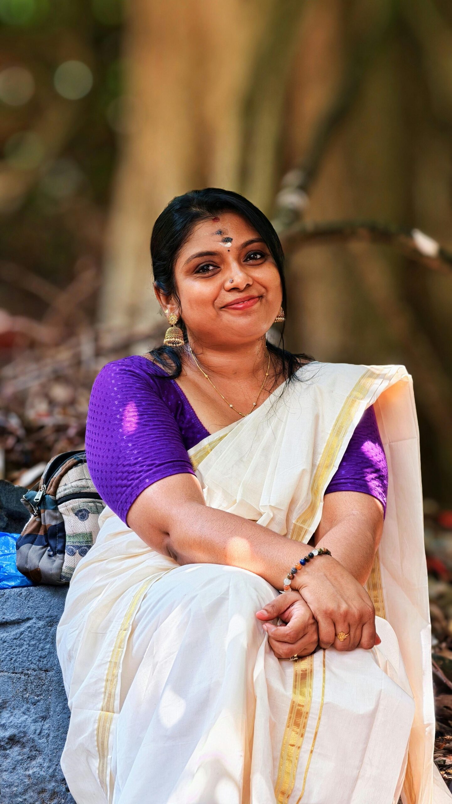 South Asian woman in Kerala saree with natural light outdoor setting.